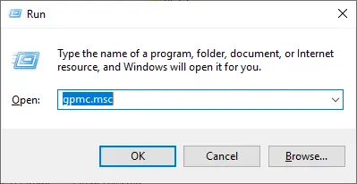 Windows Run dialog box with the command gpmc.msc entered to open the Group Policy Management Console